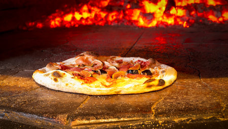 Fig and Prosciutto pizza in a wood fired ovenの写真素材