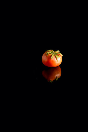 Fresh tomato on black backgroundの写真素材