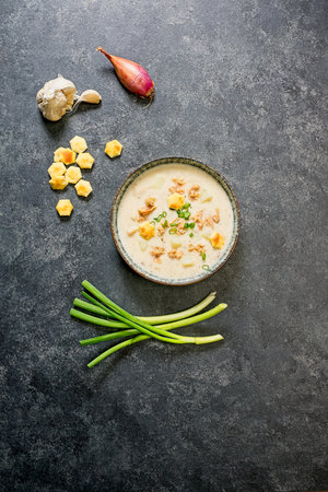 Manhattan clam chowder in bowl on black background with ingredients aroundの写真素材