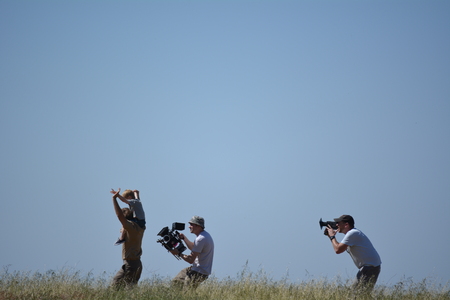 Movie set father and son run through grass camera men followのeditorial素材