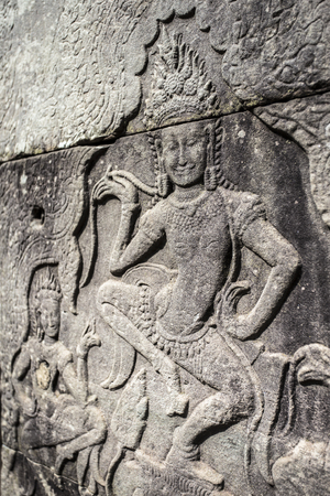 Siem Reap Angkor Wat apsara dancer ancient stone carving on wall and pillarの写真素材