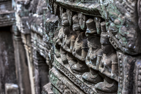 Siem Reap Angkor Wat apsara dancer ancient stone carving on wall and pillarの写真素材