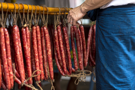 Chinese waxed sausages hung to dry in a traditional shop in Yangon Myanmar Burma South East Asia.の写真素材