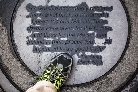 A 1878 plaque on ground declaring the opening of Queen Victoria Market Melbourne Australiaのeditorial素材