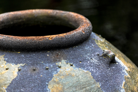 Large rusty looking ceramic clay urn for rain water retention, garden ideaの写真素材