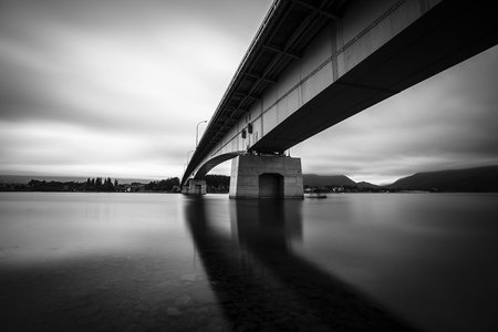Long exposure beneath a bridge in lake kawaguchi near mount fujiの写真素材