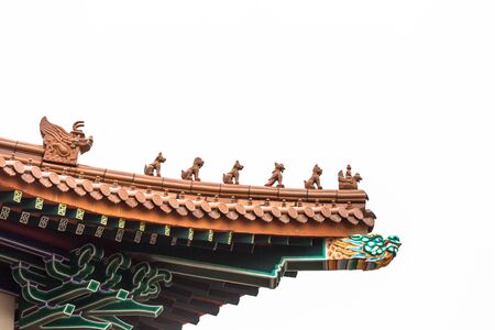 Common detailed chinese wooden roof top design with green and orange tiles