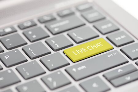 Automated smart chat bot messenger assistant to business support calls concept shown on close up enter key on notebook keyboardの写真素材