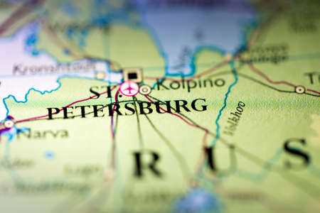 Shallow depth of field focus on geographical map location of Saint Petersburg city Russia Europe continent on atlasの写真素材
