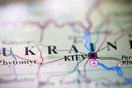 Shallow depth of field focus on geographical map location of Kiev city Ukraine Europe continent on atlasの写真素材