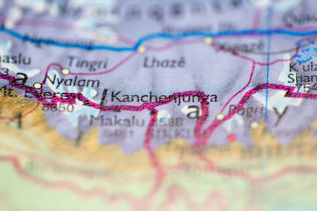 Shallow depth of field focus on geographical map location of Mount Kangchenjunga in Nepal Asia continent on atlasの写真素材