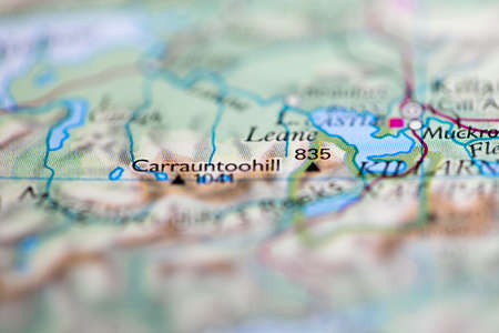 Shallow depth of field focus on geographical map location of Mount Carrauntoohil in Ireland Europe continent on atlasのeditorial素材