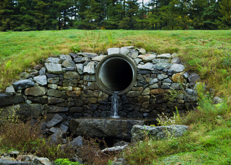 Drainage pipe in rock wall in Crotched Mountain Resort New Hampshireの写真素材