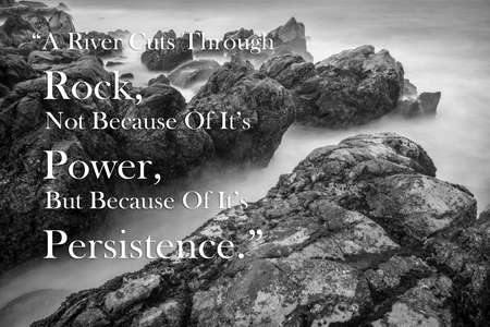 Best motivation quotes about life, success, photo on rock and sea background, A river cuts through rock, not because of its power, but because of its persistence.の写真素材