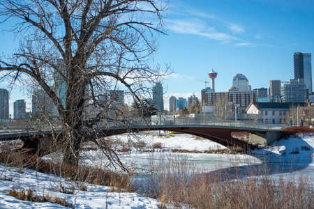Picturesque Pedestrian Bridge Crossing Over Frozen RIverの写真素材