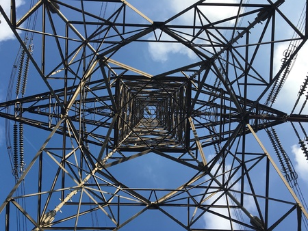Under the electricity tower with a nice weather and blue sky