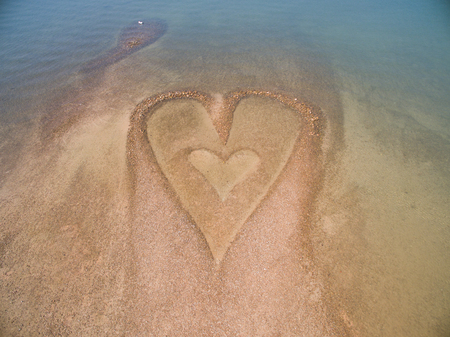 Stone heart on the beachの写真素材