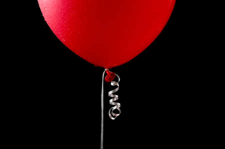 A close up of a wet red balloon.の写真素材
