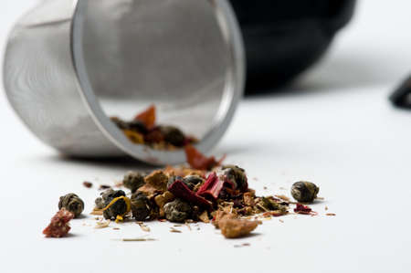 dry tea leaves spilled over onto white.の写真素材