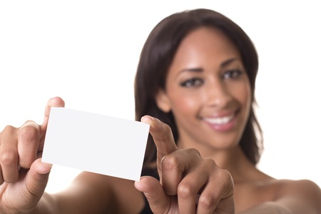 Woman holds a blank business card out in front of her smiling face の写真素材