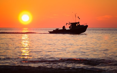 A lobster fishing boat is going to fetch his trap at early morning in Gaspesie, Quebec, Canadaの写真素材