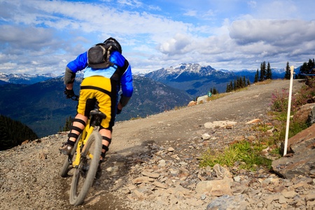 A biker is going to a downhill ride in the rocky mountains のeditorial素材