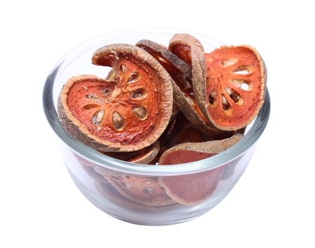 Bael Fruit in glass bowl on white backgroundの写真素材