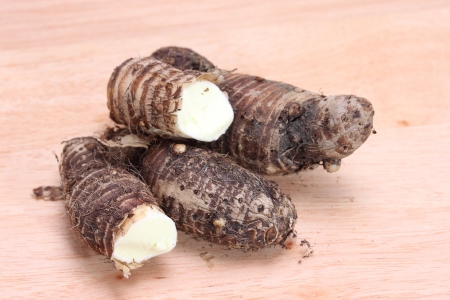 Taro roots on Wooden cutting boardの写真素材