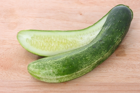 Cut of cucumber on wooden cutting boardの写真素材