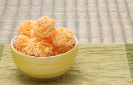 Traditional Thai Dessert, Egg yolk thread  Khanom Foi Thong  in bowl isolated on cloth matの写真素材
