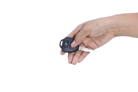 female hand holding remote control car key on white background
