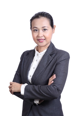 Portrait of a smiling young businesswoman with arms crossedの写真素材