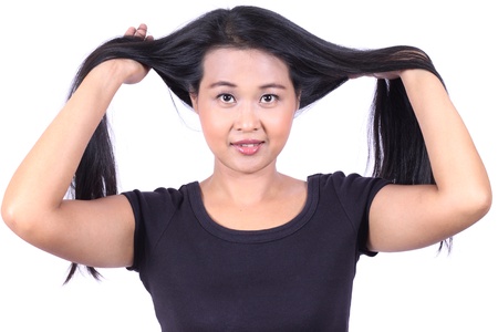 beautiful woman pulling their long tresses isolated on  white backgroundの写真素材