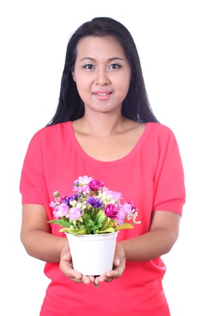 Young woman holding artificial flower,  isolated on white background.の写真素材
