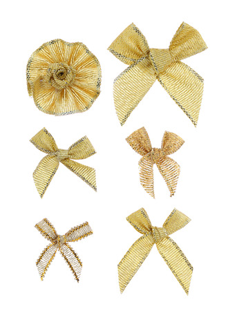 Festive gold bows made of ribbon. Isolated on a white background.の写真素材