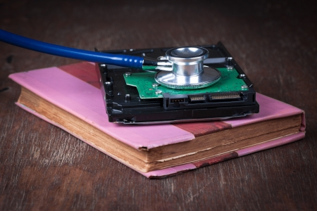Medical concept, stethoscope with computer hdd on wood table
