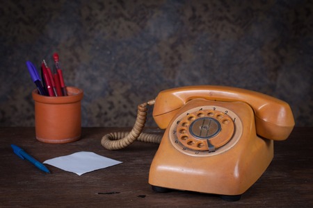 Old telephone on wood table. Still lifeの写真素材