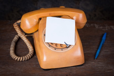 Old telephone on wood table. Still lifeの写真素材