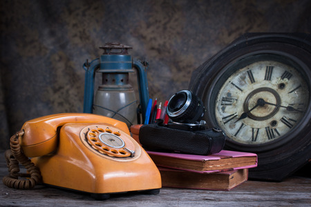 Group of objects on wood table. old telephone, type writer, old camera, Still lifeの写真素材