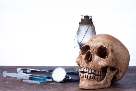 Medical concept , Weathered human skull and syringeの写真素材