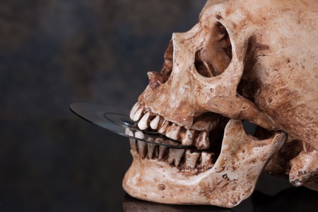 Human skull and dvd in mouthの写真素材