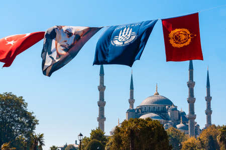 ISTANBUL - September 25, 2012: The flags of Ataturk flutters on a wire in front of the famous Blue Mosque. Mustafa Kemal Ataturk 1881-1938 was the first president of the Republic of Turkey and his Reforms modernized the country.のeditorial素材