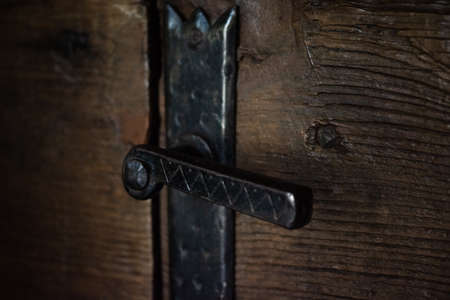 Iron handle of an ancient wooden doorの写真素材