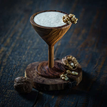 Cocktail martini in wooden glass on wooden background.の写真素材