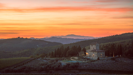 Tuscan Chianti Sunset Overlooking a Cottage, Cypress Trees, and Rolling Hillsの写真素材
