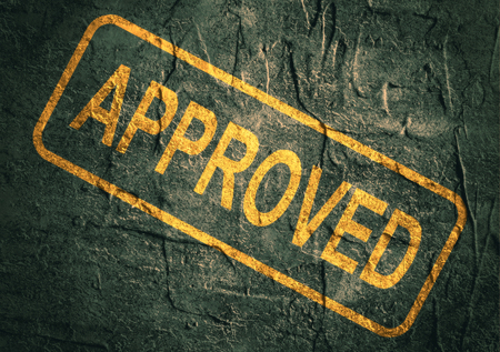 stamp approved with text over concrete textured backgroundの写真素材