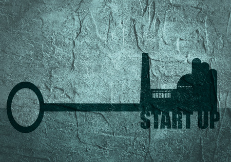 Flat design style modern illustration concept of hand holding a key of industry start up. Factory icon and text on key. Concrete texturedの写真素材