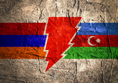 Image relative to politic relationships between Armenia and Azerbaijan. National flags on triangles banner divided by high voltage sign. Concrete texturedの写真素材