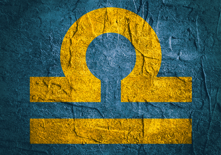 Scales astrology sign. Yellow astrological symbol on concrete textured backdropの写真素材