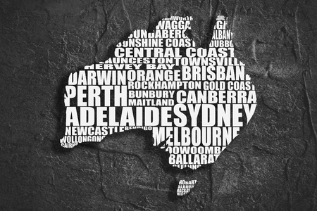 Map of Australia made from cities list. Grunge textured backdrop. Monochrome imageの写真素材